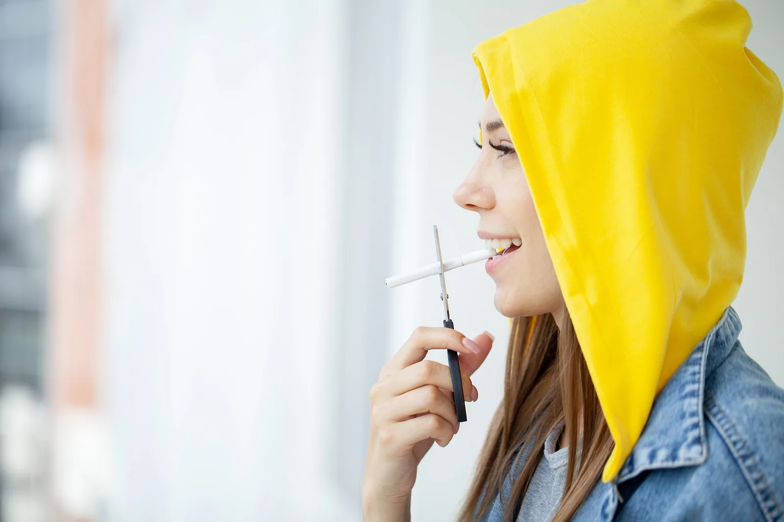 Stop smoking, woman cuts a cigarette with scissors