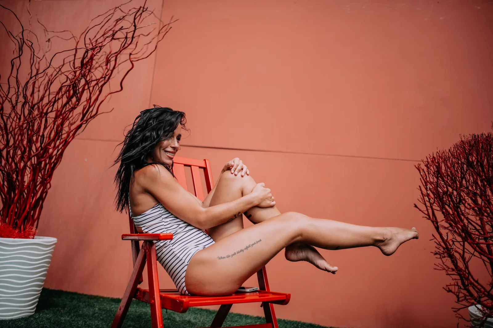 Candid caucasian black hair young adult lady in swimsuit spending summer vacation in the open air